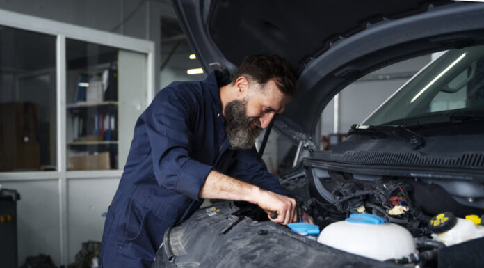 Male mechanic working on car in the auto repair shop