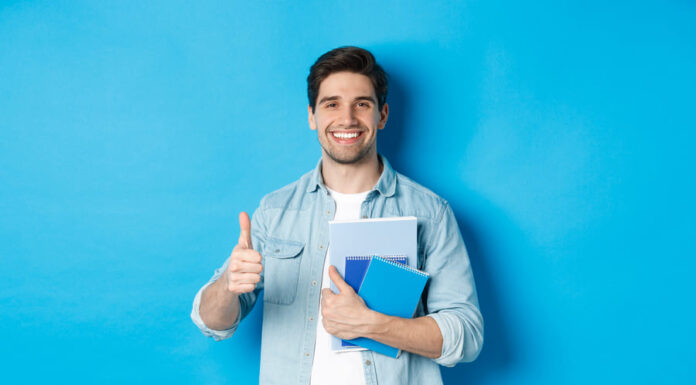Young man student with notebooks