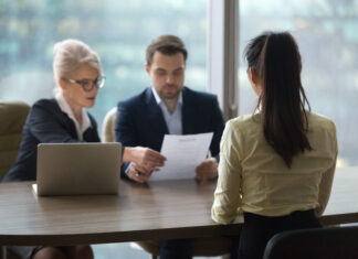 Back view of female candidate apply for position, interview in modern office