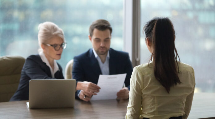 What is an Employer of Record Service? Comprehensive Guide for Global Employers Back view of female candidate apply for position, interview in modern office