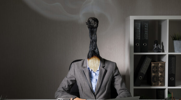 The Role of Leadership in Combating Burnout: How Effective Talent Management Starts at the Top Burnout woman working at the office