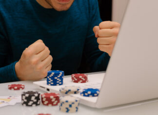 Gamer man playing with his laptop from home to casino games