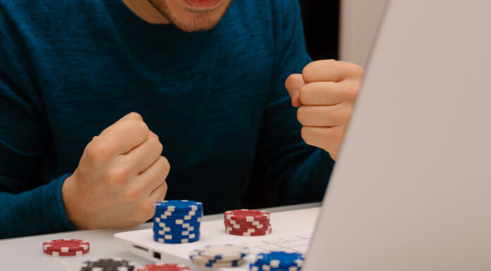 Gamer man playing with his laptop from home to casino games