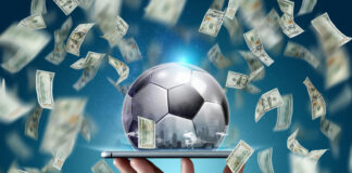 Speed vs. Security: What to Consider When Choosing a Fast Payout Sportsbook Dollars are falling on the background of a hand with a smartphone and a soccer ball