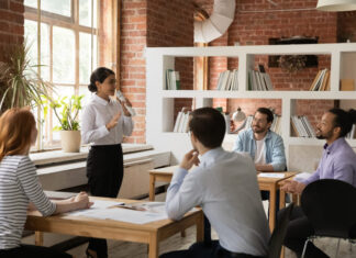 Using Stories to Create Exceptional Performance Female employee sharing stories to her colleague