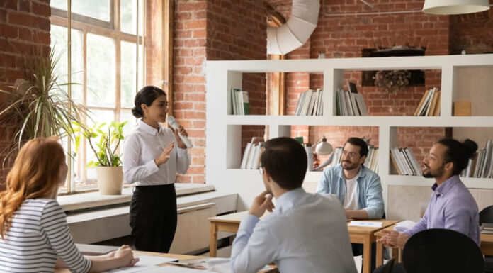 Using Stories to Create Exceptional Performance Female employee sharing stories to her colleague