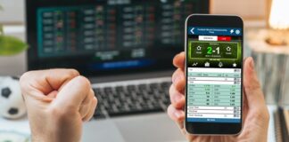 Sports Betting: A Beloved Pastime in Thailand Male fist clenched with triumph in front of laptop screen.