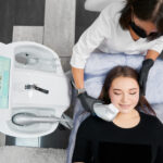 Female skill-advanced doctor holding modern medical equipment for non-surgical face lifting