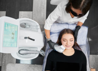 Female skill-advanced doctor holding modern medical equipment for non-surgical face lifting