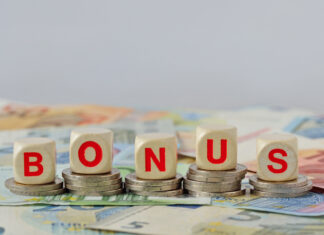Wooden blocks with the word Bonus on coins and banknotes