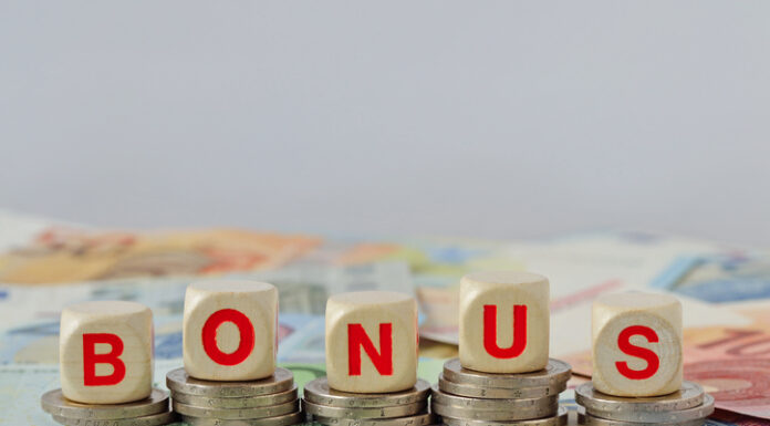 How No Deposit Bonuses Shape Young People’s Gambling Habits? Wooden blocks with the word Bonus on coins and banknotes