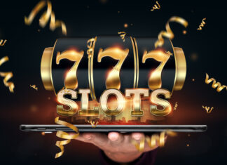 Online casino, smartphone with slot machine with jackpot and gold coins