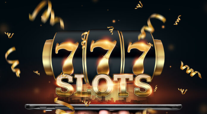 Online casino, smartphone with slot machine with jackpot and gold coins