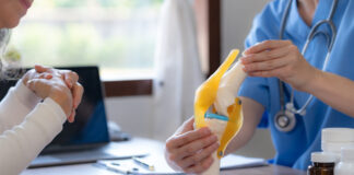 Top Hospitals for Orthopedic Surgery: A Comprehensive Overview Female doctor who is explaining the treatment method of the knee joint to the woman patient