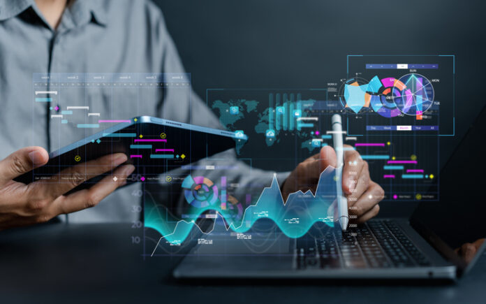 Analyst working with computer in Business Analytics and Data Management System to make report with KPI and metrics connected to database. Corporate strategy for finance, operations, sales, marketing. Analyst working with computer in Business Analytics and Data Management System