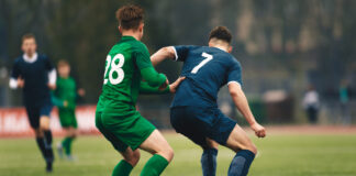 Measuring Player Impact in Live Football League Games: Quantifying On-Field Contributions Adult football competition. Soccer football player dribbling a ball and kick a ball during match in the stadium