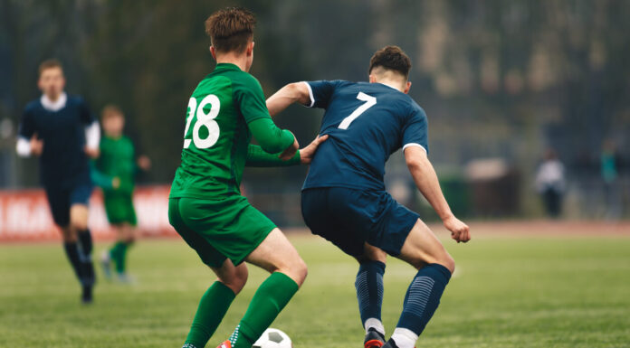 Measuring Player Impact in Live Football League Games: Quantifying On-Field Contributions Adult football competition. Soccer football player dribbling a ball and kick a ball during match in the stadium