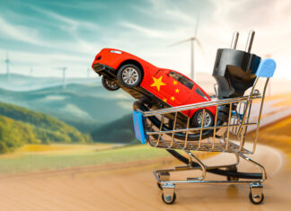 Toy car with the chinese flag and electrical plug inside a small shopping cart