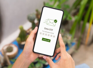 Hand using smartphone and mobile OTP secure verification