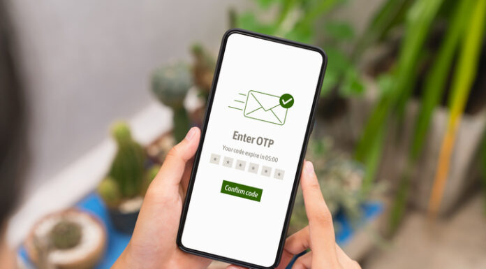 Hand using smartphone and mobile OTP secure verification