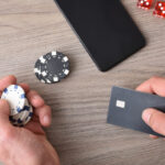The Problems that Affect High Rollers But Not Regular Gamblers Casino game player accessing payment card to make virtual bets