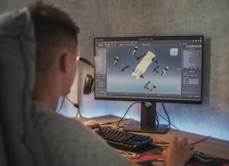 Young designer creates 3D model and animation of the robot dog on computer
