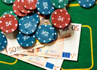 Poker chips and bills at a poker table