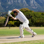 Full length of cricketer playing on field