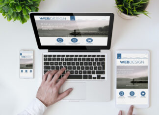 Smartphone and laptop showing web design website.