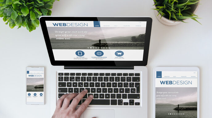 Smartphone and laptop showing web design website.