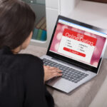 Woman Lying On Couch Using Online Dating Application On Laptop