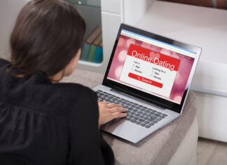 Woman Lying On Couch Using Online Dating Application On Laptop