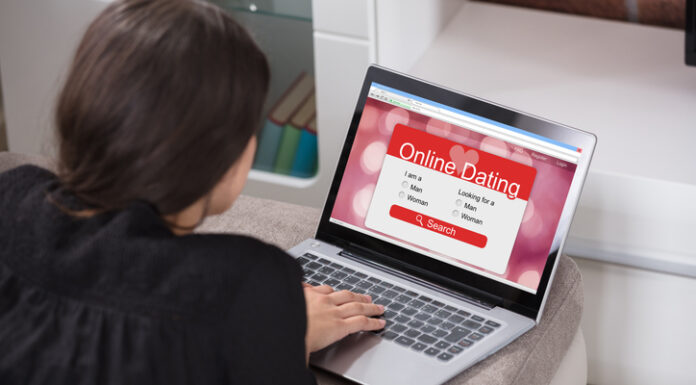 Woman Lying On Couch Using Online Dating Application On Laptop