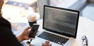 Understanding Random Number Generators and their Commercial Uses Person Holding Smartphone while using Laptop