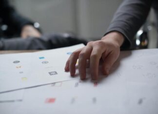 Top 3 Trends in Logo Design for Innovative Businesses Hand on Top of Paper