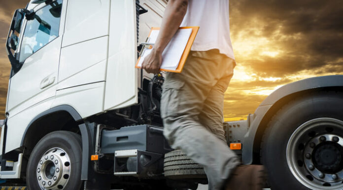 Truck transportation, truck driver walking around semi truck inspecting and safety check before driving a truck