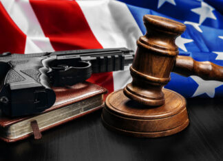Gun Ruling on Domestic Abusers’ Rights Prompts Rebuke Gavel on wooden table with USA flag