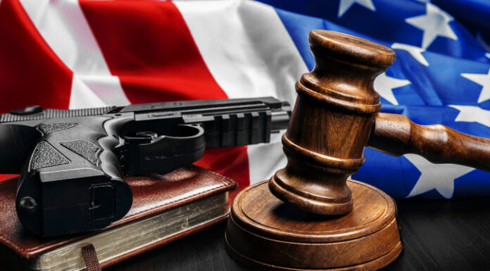 Gun Ruling on Domestic Abusers’ Rights Prompts Rebuke Gavel on wooden table with USA flag