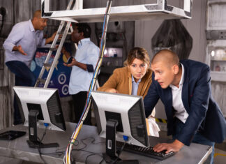 Are Escape Rooms a Healthy Team Activity? Data Says Yes People are solving puzzles on computer in escape room stylized laboratory