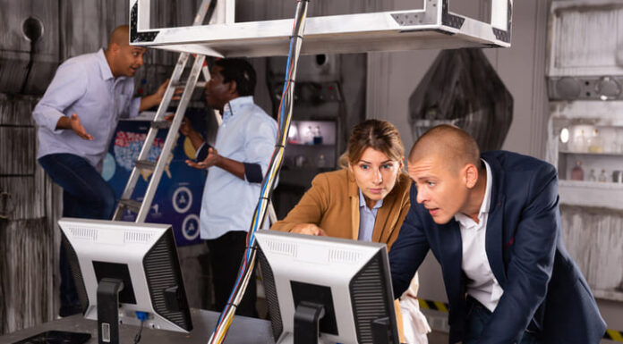 People are solving puzzles on computer in escape room stylized laboratory