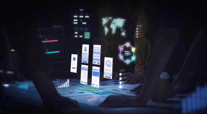 Mobile App Perks: A Must for your Business Growth UI designer use augmented reality app brainstorming about mobile interface wireframe design on desk at night in office