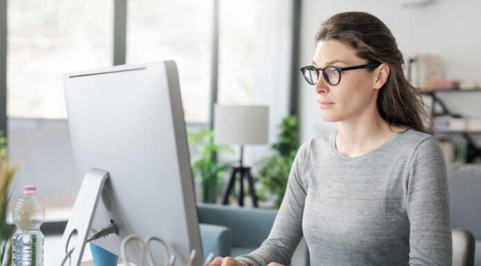 Intermediate Vision: Things to Know for Healthy Eyes Professional woman sitting at desk and connecting with her computer