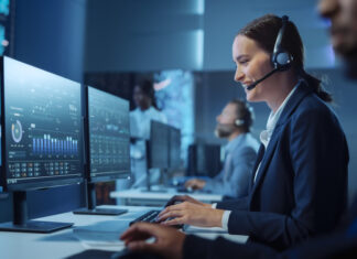 Technical Customer Support Specialist Having a Headset Call while Working on a Computer