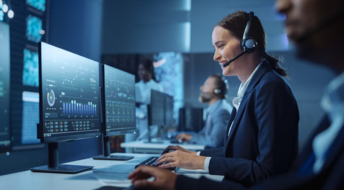 Technical Customer Support Specialist Having a Headset Call while Working on a Computer