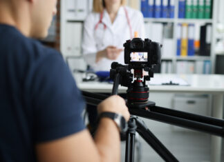 How Healthcare Video Production Enhances Patient Engagement and Boosts Hospital Marketing Strategies Photographer filming doctor on camera using tripod and slider closeup