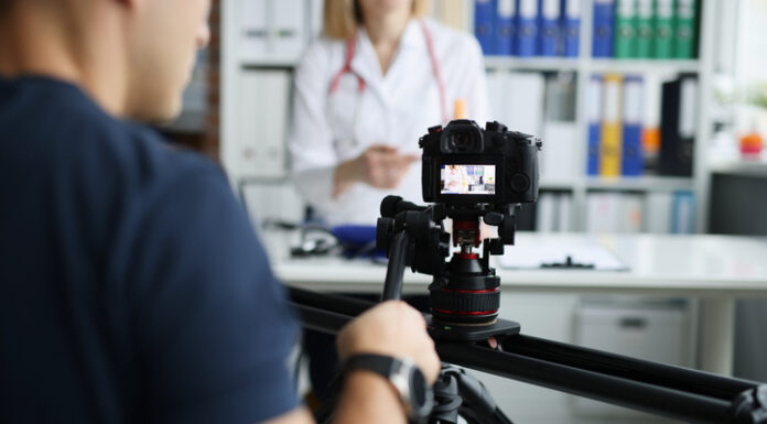 Photographer filming doctor on camera using tripod and slider closeup