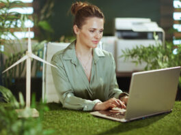 Pensive elegant business woman in green office working
