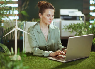 Pensive elegant business woman in green office working