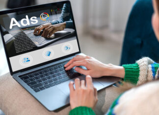 The Advantages of Virtual Cards for Advertisers on Google Ads, Facebook Ads, and Microsoft Ads Woman using laptop with advertising Ads on computer