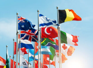 One Young World’s Kate Robertson: Peace is Possible Set of flags fluttering in the wind against blue sky